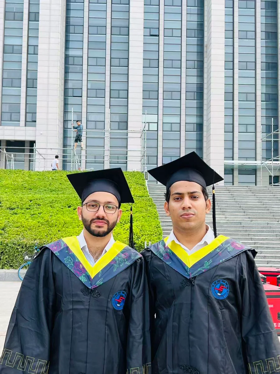 Ali Khan with a fellow graduate