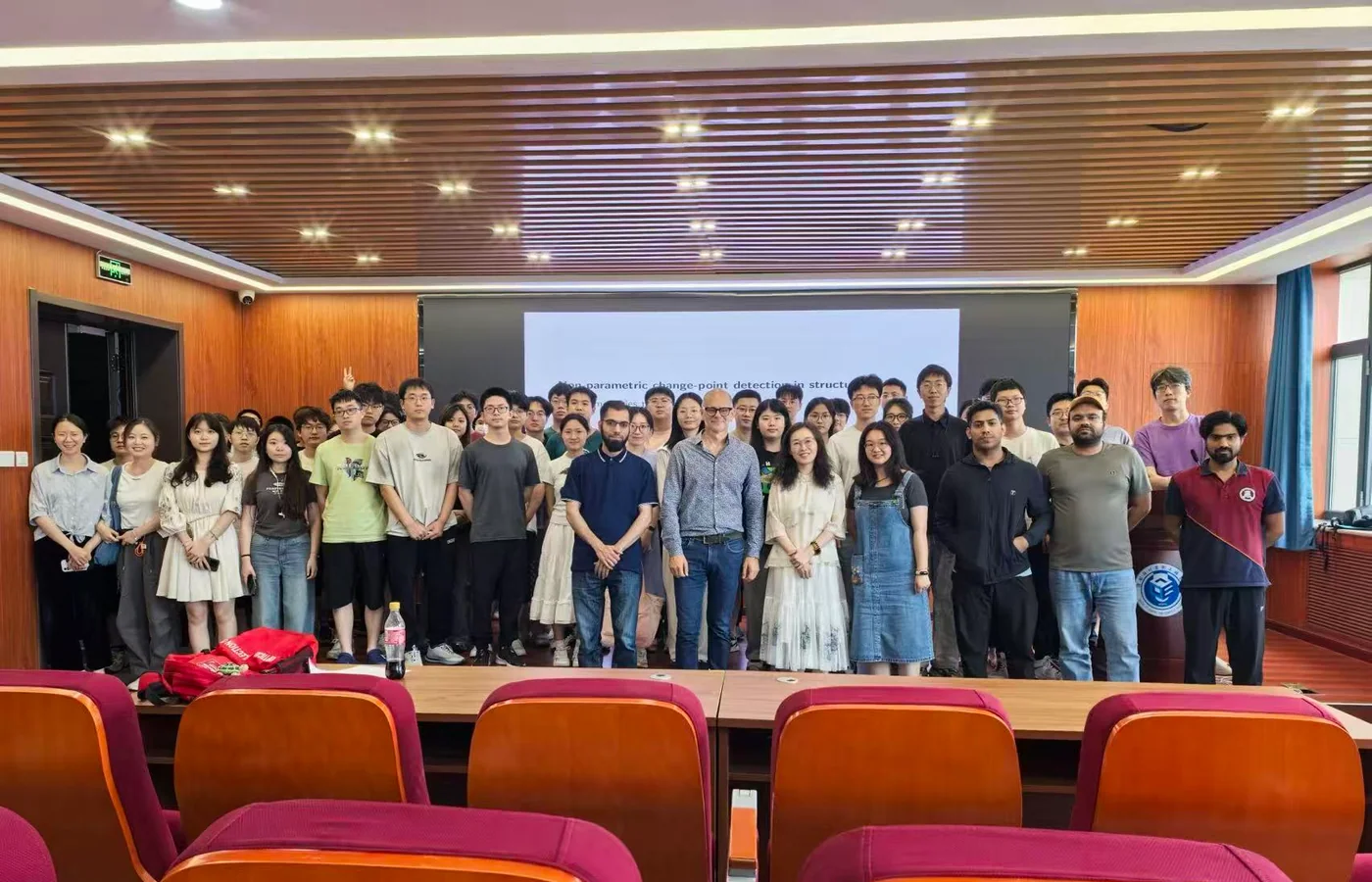 Research community gathered in an auditorium